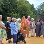 Relatives of those affected by the bombing gather around the Meco Memorial at its unveiling